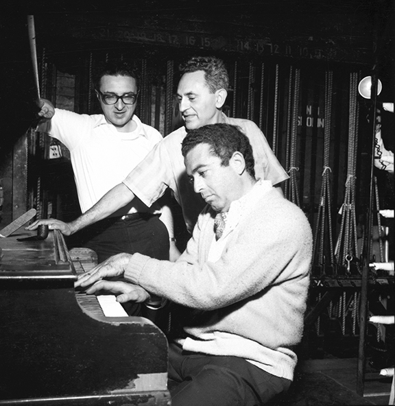 Sheldon Harnick watches as Jerry Bock plays the piano and Joseph Stein gives directions.