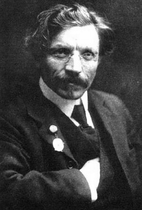 A black and white photograph of Sholem-Aleichem posing for a portrait.